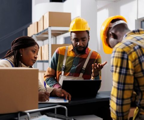logistics-department-managers-planning-stock-supply-schedule-warehouse-counter-desk-all-black-storehouse-employees-team-managing-parcel-registration-dispatching-process_482257-71414 logistics-department-managers-planning-stock-supply-schedule-warehouse-counter-desk-all-black-storehouse-employees-team-managing-parcel-registration-dispatching-process_482257-71414